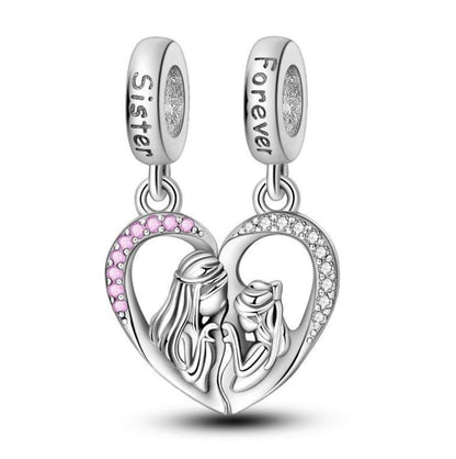 Heart-shaped silver charm with 'Sister' and 'Forever' text, pink accent, and two women silhouette on a white background.